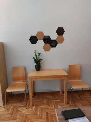 a table with two chairs and a plant on a wall at Christina-Anna Athens City Center walking distance to everywhere and Acropolis, in One of the most Favorable Locations by National Gardens and Zoo, Hellenic Parliament in Syntagma and Stylish Exquisite Kolonaki Cozy Renovated Apartment in Athens