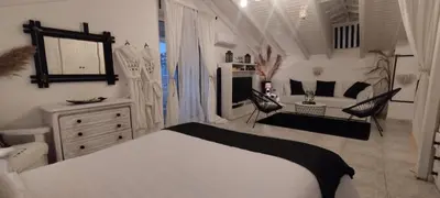 a white bedroom with a bed and a living room at Villa Maria Lagonissi - Private Villa upstairs with exclusive access to pool & outside areas in Kalívia Thorikoú