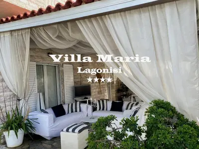a patio with white furniture and a sign that reads villa marina lagoon at Villa Maria Lagonissi - Private Villa upstairs with exclusive access to pool & outside areas in Kalívia Thorikoú