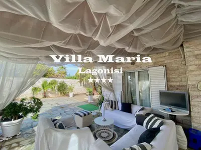 a living room with couches and a tv under a tent at Villa Maria Lagonissi - Private Villa upstairs with exclusive access to pool & outside areas in Kalívia Thorikoú