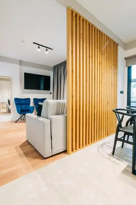 a living room with a white chair and a table at Athesense Suites in Athens