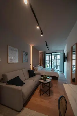 a living room with a couch and a bed at Athesense Suites in Athens