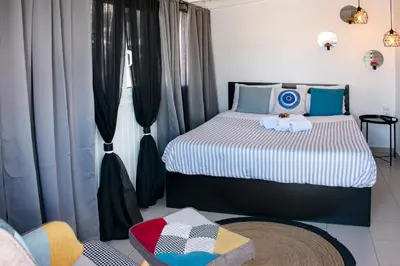 a bedroom with a bed and a chair in it at The Athenian Oasis in Athens