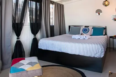 a bedroom with a bed with two stuffed animals on it at The Athenian Oasis in Athens