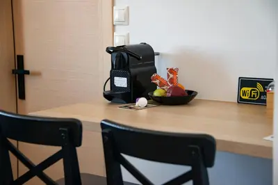 a counter with a bowl of fruit and a phone at The Athenian Oasis in Athens