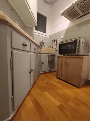 a kitchen with a microwave and a refrigerator at Comfy in Kypseli in Athens