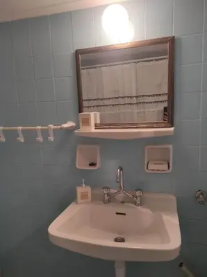 a bathroom with a sink and a mirror at Comfy in Kypseli in Athens