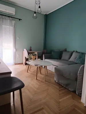 a living room with a couch and a table at Comfy in Kypseli in Athens