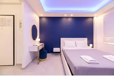 a bedroom with a large bed and a blue wall at Monastiraki Heart - Luxury Apartment Athens in Athens