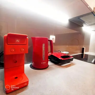 a red coffee maker and a blender on a counter at Monastiraki Heart - Luxury Apartment Athens in Athens