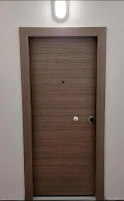 a wooden door in the corner of a room at Monastiraki Heart - Luxury Apartment Athens in Athens