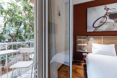 a bedroom with a bed and a bike on the wall at Laskareos Apartment by Olala Homes in Athens