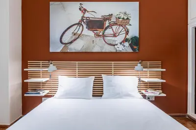 a bedroom with a bed with a bike on the wall at Laskareos Apartment by Olala Homes in Athens