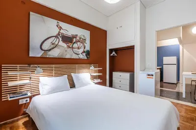 a bedroom with a bed with a bike on the wall at Laskareos Apartment by Olala Homes in Athens