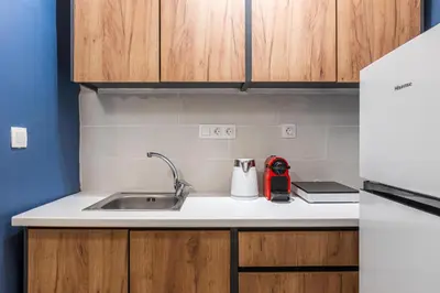 a kitchen with a sink and a red appliance at Laskareos Apartment by Olala Homes in Athens