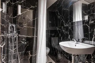 a black and white bathroom with a sink and a toilet at Laskareos Apartment by Olala Homes in Athens