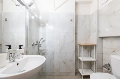 a white bathroom with a shower and a sink at Alexandras Apartment by Olala Homes in Athens