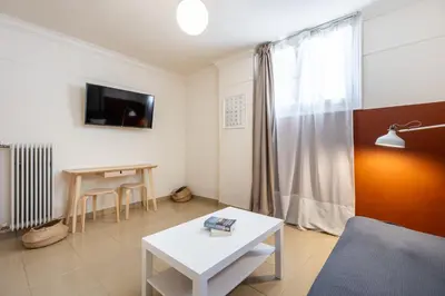 a living room with a couch and a table at Alexandras Apartment by Olala Homes in Athens