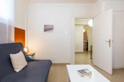 a living room with a blue couch and a table at Alexandras Apartment by Olala Homes in Athens