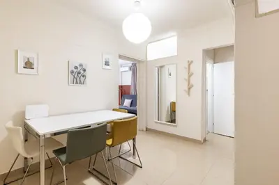 a white dining room with a white table and chairs at Alexandras Apartment by Olala Homes in Athens