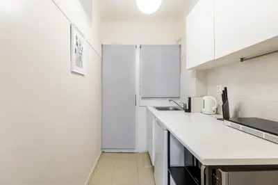 a kitchen with white cabinets and a white counter top at Alexandras Apartment by Olala Homes in Athens