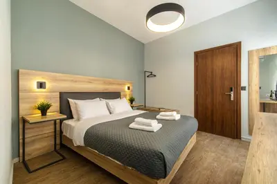 a bedroom with a bed with two towels on it at Karma Athens II in Athens
