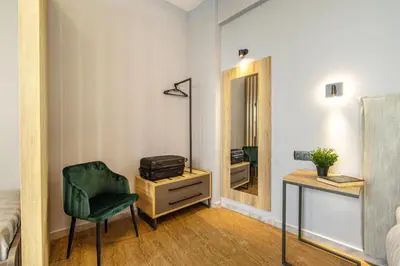 a bedroom with a desk and a chair and a mirror at Karma Athens II in Athens