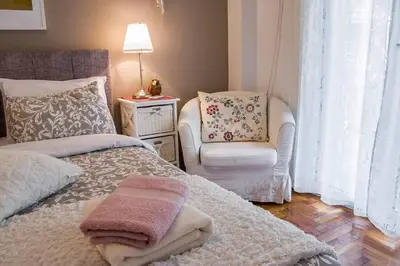 a bedroom with a bed and a chair at City stay Ambelokipi Panormou '' cozy apartment'' in Athens