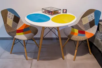 a table with two chairs and a table with a box on it at City stay Ambelokipi Panormou '' cozy apartment'' in Athens