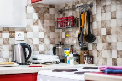 a kitchen with a stove and a counter with utensils at City stay Ambelokipi Panormou '' cozy apartment'' in Athens