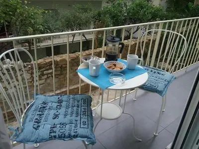 a table and two chairs on a balcony at City stay Ambelokipi Panormou '' cozy apartment'' in Athens