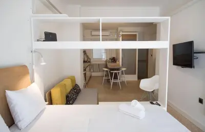 a bedroom with a bed and a living room at Syntagma View Apartment in Athens