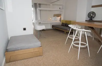 a room with a bed and a desk and a table at Syntagma View Apartment in Athens