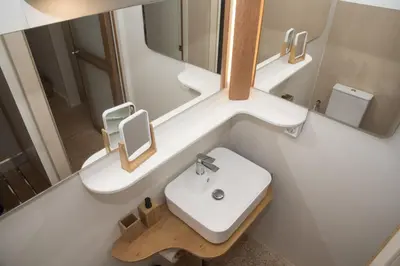 a bathroom with a white sink and a mirror at Syntagma View Apartment in Athens