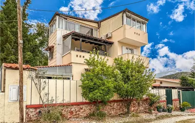 a house with a fence in front of it at 3 Bedroom Cozy Home In Koropi in Koropíon