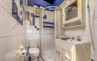 a small bathroom with a toilet and a sink at 3 Bedroom Cozy Home In Koropi in Koropíon