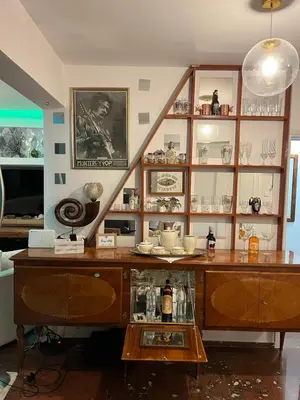 a room with a table and a shelf with items at Luxurious 2-Bed Seaside Apartment in Saronida in Saronida