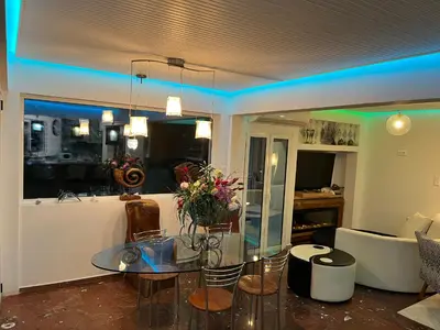 a living room with a glass table and a couch at Luxurious 2-Bed Seaside Apartment in Saronida in Saronida