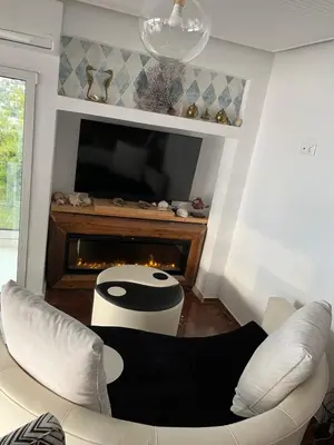 a living room with a couch and a fireplace at Luxurious 2-Bed Seaside Apartment in Saronida in Saronida