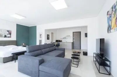 a living room with a couch and a bed at Hip And Fun Apt B in Athens