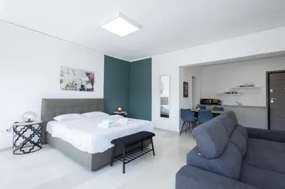 a bedroom with a bed and a couch at Hip And Fun Apt B in Athens