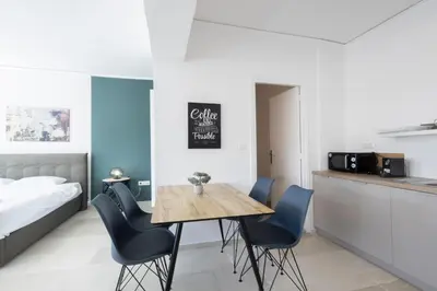 a room with a table and chairs and a bed at Hip And Fun Apt B in Athens