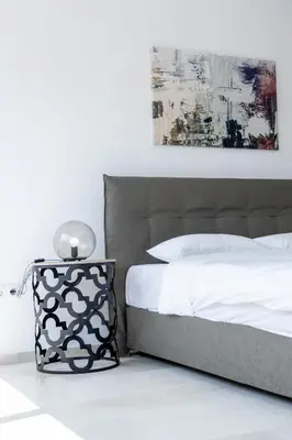 a bedroom with a white bed and a black and white pillow at Hip And Fun Apt B in Athens