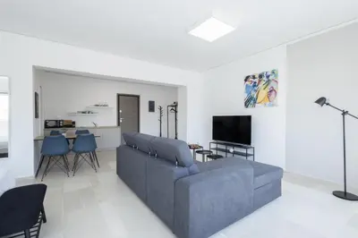 a living room with a couch and a tv at Hip And Fun Apt B in Athens