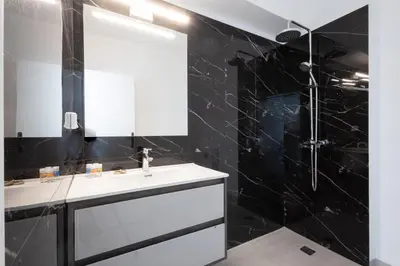 a bathroom with a white sink and a mirror at Hip And Fun Apt B in Athens