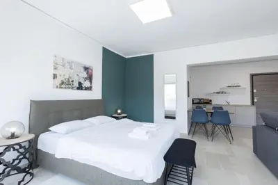 a bedroom with a white bed and blue walls at Hip And Fun Apt B in Athens