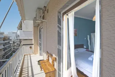 a bedroom with a bed on a balcony at Andromaxi 2BR Apt near SNFCC, AC, WiFi in Athens
