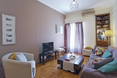 a living room with two couches and a coffee table at Andromaxi 2BR Apt near SNFCC, AC, WiFi in Athens