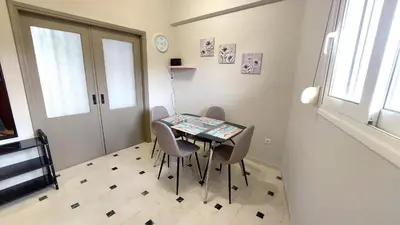 a small dining room with a table and chairs at VISTA MARE beachfront apartment. in Saronida