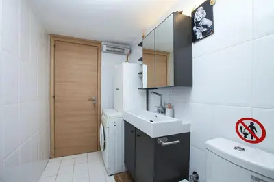 a small bathroom with a sink and a refrigerator at Divine Home Beach Retreat in Anavissos